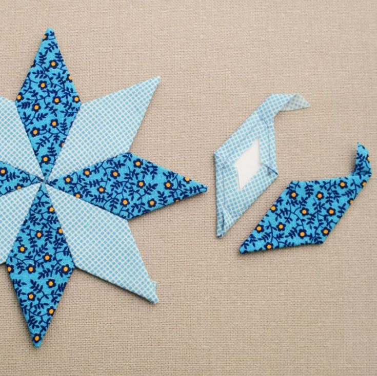 After the hexagon, the diamond is likely the second most common EPP shape. Changing the width of a diamond creates an infinite number of pattern possibilities. This 8-pointed star applique is made from diamond EPP.