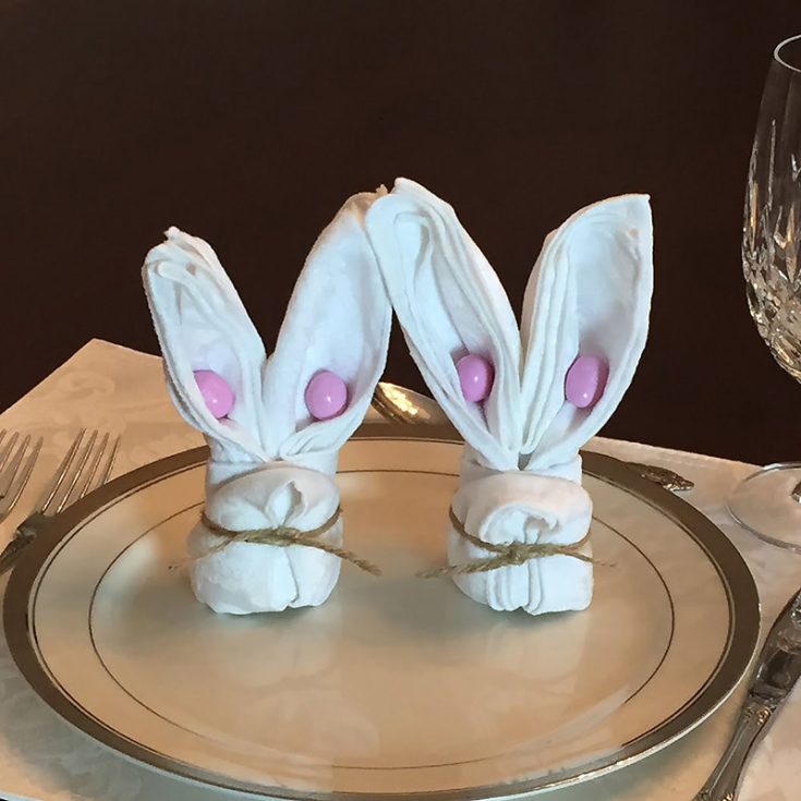 Check out this adorable bunny napkin craft that will leave your guests stunned by how detailed it is. These would pair up lovely with some ornamental flowers on your guest's plate with a name tag.&nbsp;
