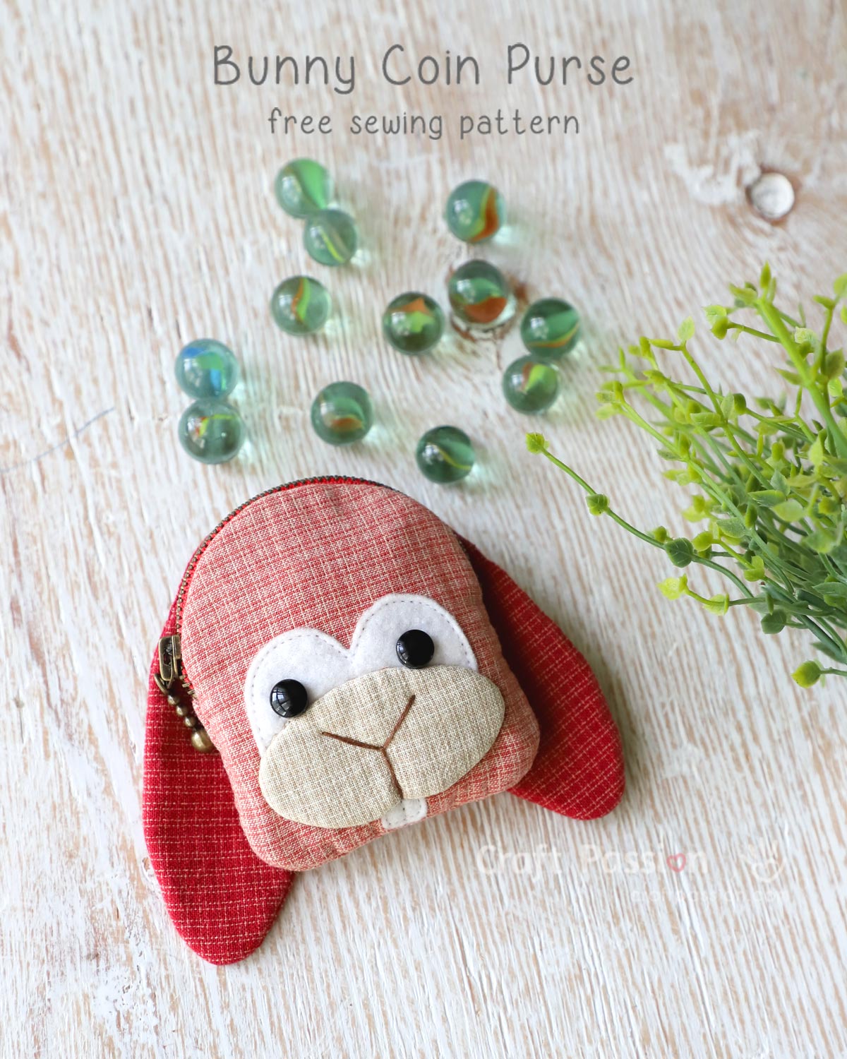 Free purse sewing pattern to sew an adorable bunny coin purse with zipper closure. A small bunny pattern purse with a pair of long ears in cherry color, in palm size.
