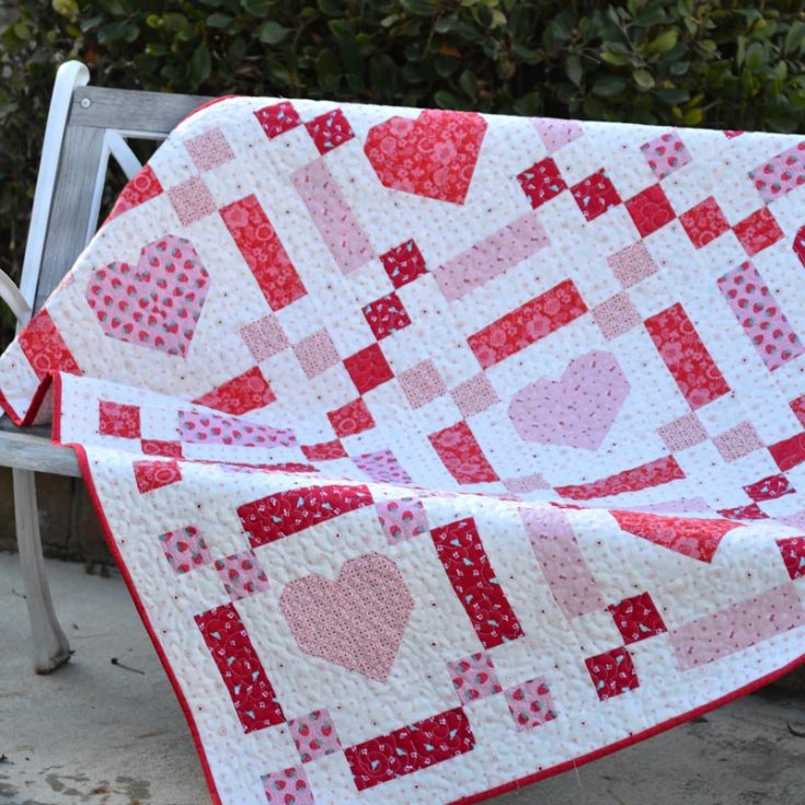 Make this lovely beginner-friendly quilt pattern with red and pink hearts! It&rsquo;s constructed with five fat quarters, resulting in a 50&rdquo; x 50&rdquo; quilt with an Irish Chain style with pieced hearts in the center.