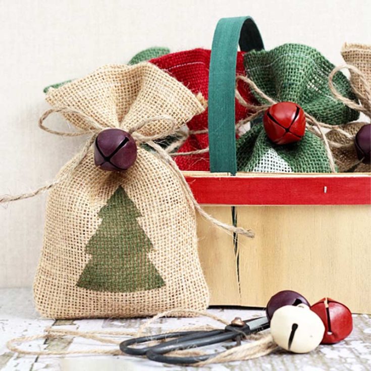 Get your holiday crafting on with these DIY burlap gift bags! Stamp on your favorite Christmas designs with stencils, paint, and sponges. Add twine and a bell for some finishing touches, and you&rsquo;ve got the cutest bags that will spread all the classic festive vibes!