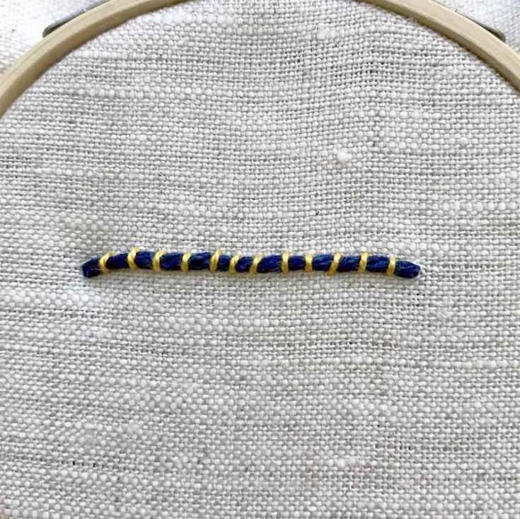 Couching is a technique where a surface material is attached to the surface of a textile with small stitches. The surface material can be anything ranging from dried flowers to yarn or strips of fabric.
