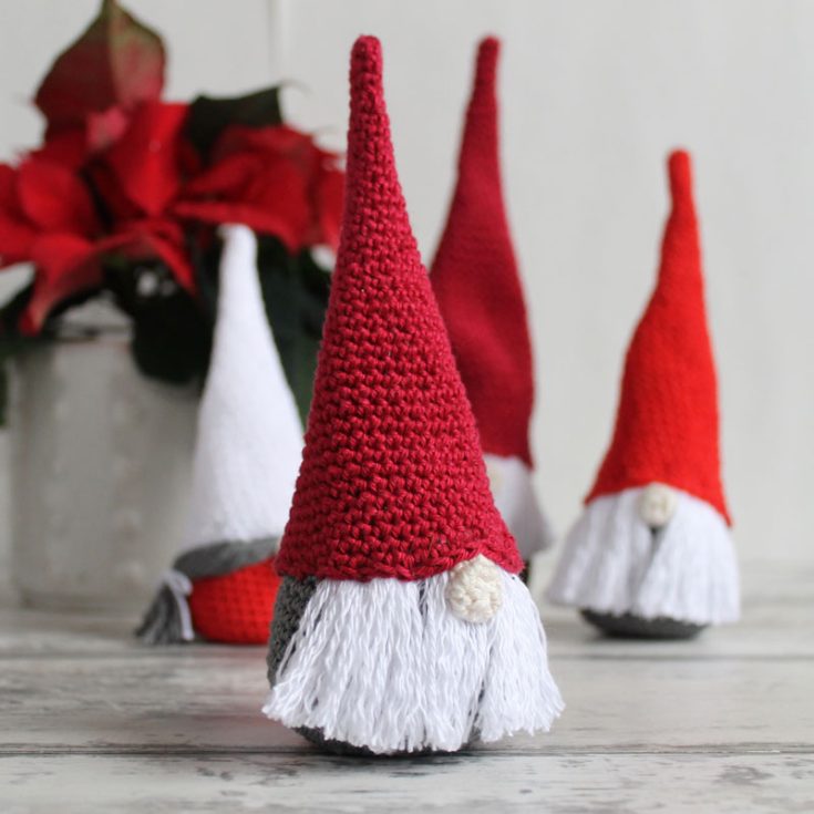 These crochet Christmas gnomes are so simple, you can easily whip up a whole collection in a day using different shades of red, gray, and white!