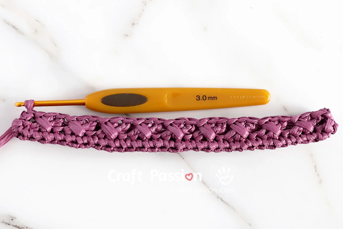 crochet crossbody bag base first round of cable stitch on a small crochet crossbody bag