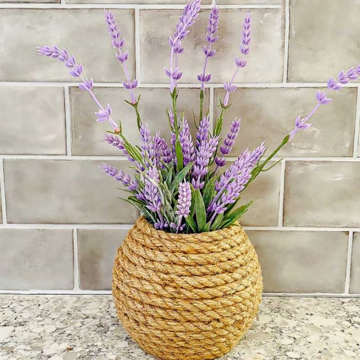 Bring a coastal vibe into your home with this homemade nautical rope vase craft while adding a rustic touch to your decor. This DIY craft is so beginner friendly and beautiful that your guests won't be able to tell that you made it yourself. Fill it with seasonal faux flowers from the dollar store for a pop of color.