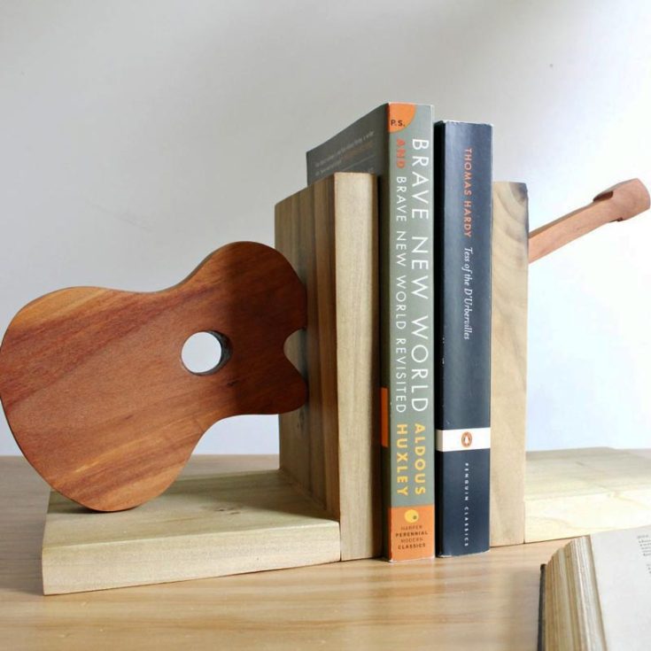 Strum a tune of creativity and knowledge with this DIY Wooden Guitar Bookend! Add a musical touch to your bookshelf and create a music ensemble right in your bookshelf! Try out this design!