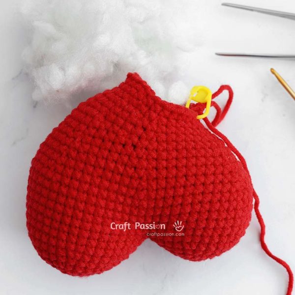 Stuffing the whimsical heart amigurumi with polyester fiberfill