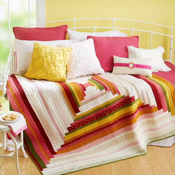 Wrap yourself in a courthouse steps-style quilt with this lovely design. With its playful interpretation of the classic log cabin pattern, this quilt has a rustic vibe. Perfect for any occasion or as a thoughtful gift to someone you love. The finished size is 69 &frac12;&rdquo; x 71 &frac12;&rdquo;.
