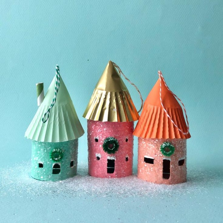 Deck the halls with these adorable mini house ornaments made from toilet paper rolls and cupcake wrappers! Cut the rolls into smaller sections, then decorate them with paint, glitter, and miniature Christmas wreaths. Hang them on your tree or use them to adorn presents for a festive touch.