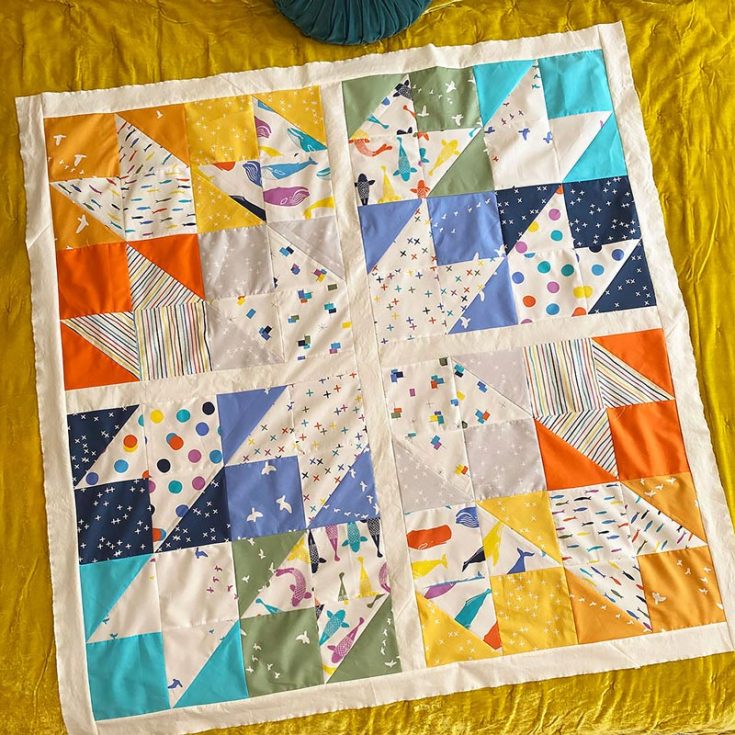 Have a look at this scrappy quilt design! It features two sizes for an original throw that measures 54" x 54" and a wall hanging/play mat size that finishes at 27" x 27". It's a design made for using up small pieces of small scraps, and it incorporates the 4-at-a-time HST method.&nbsp;