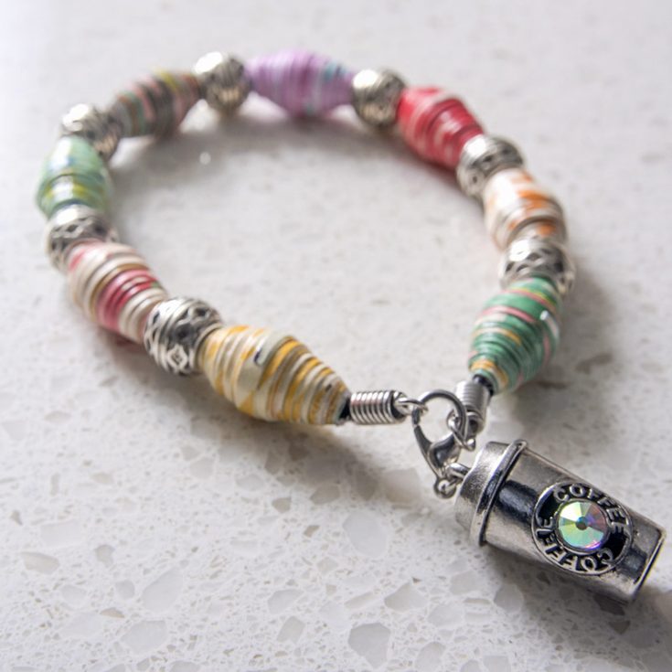 Paper beads can be surprisingly sturdy, especially for jewelry. Upcycle old colorful magazine pages into fashionable accessories like this paper bead bracelet!