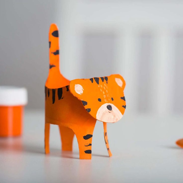 Check out this adorable cardboard tube tiger! Cut the toilet paper roll to create the shape for their 3D tiger with four legs and a tail. Paint on their distinctive orange and black striped coat and then add a face.