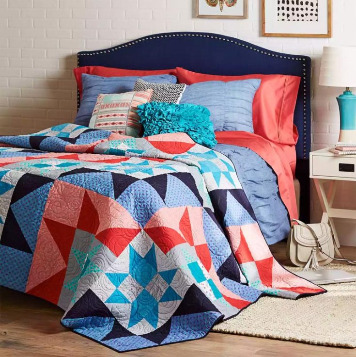 Check out this Supernova quilt pattern that offers a stunning bed-sized quilt with alternating blocks in vibrant colorways as its distinctive features. The finished quilt measures 96 &frac12;&rdquo; x 96 &frac12;&rdquo;, with each block measuring 24&rdquo; squares. This lovely design combines shades of navy, turquoise, coral, and gray for a captivating visual effect. Try it now!&nbsp;