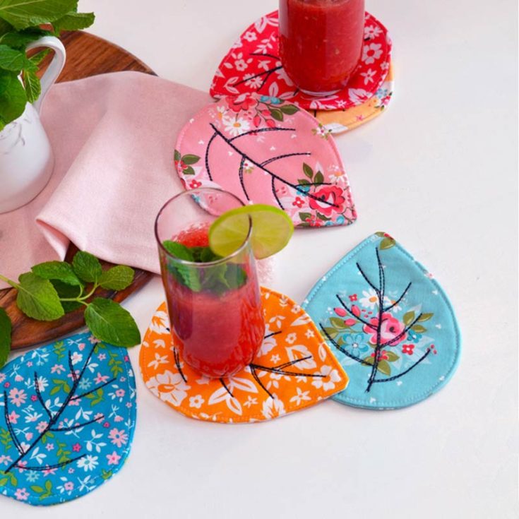 Get into the cozy fall spirit with these quilted leaf coasters, which are ideal for sipping warm drinks while enjoying the gentle fall of leaves from trees. It's the perfect project for keeping your hands busy during a snug night.