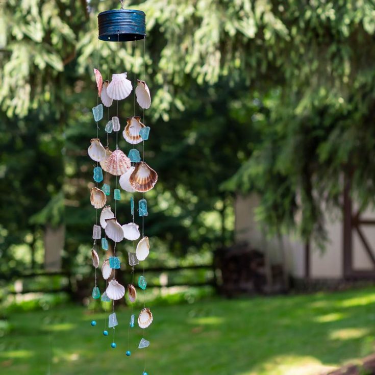 This DIY wind chime adds a relaxing melody and a touch of beauty to any space. Seashells, sea glass, and beads together create a charming coastal look. Arrange your shells and glass in a fun pattern, and enjoy the lovely chime sound as they gently clink together!