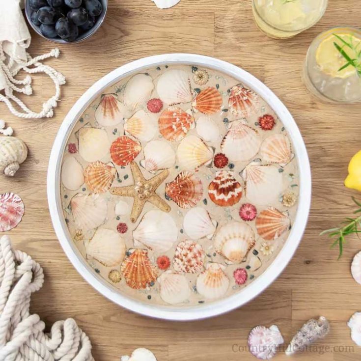 Turn seashells you collected over the summer into a DIY beach tray to serve your guests&rsquo; refreshments on! This easy summer craft turns your beach finds into a charming serving tray with just a few simple steps and resin.