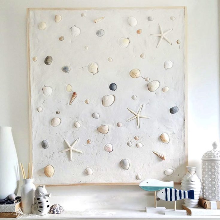 Create a summer mantel with a touch of coastal charm by plastering over a frame and embedding seashells before it dries. This simple yet stylish project adds a beachy vibe to your decor, perfect for capturing that summer feeling all year round whenever you look above your fireplace!