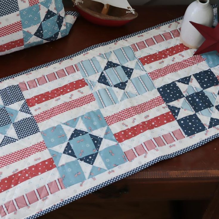 Make this beautiful quilted table runner with red, white, and blue scrap fabric! Whether you're looking to make this for the fourth of July or decorate your home with an Americana-themed decor, this table runner is made with quarter-square triangle blocks that will be taught in video and written format.&nbsp; Quilted pillow size: 20" x 20" Table runner size: 14" x 32"