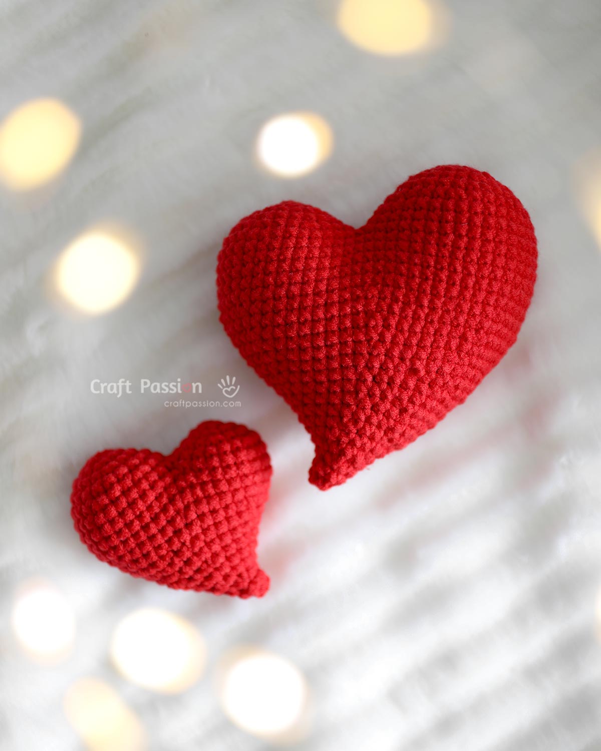 Finished whimsical curvy heart amigurumi with uneven bumps and curved tail