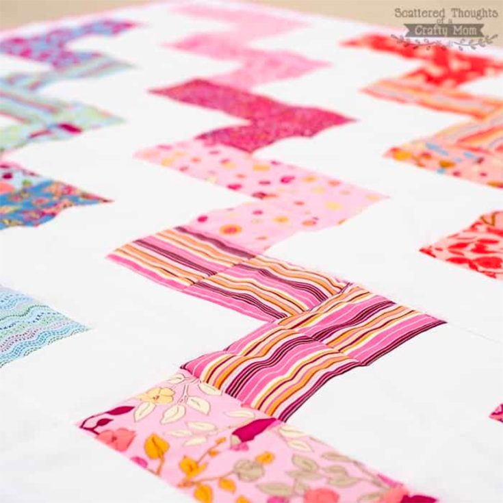 This 58" x 68" quilt pattern has this color gradient zig-zag pattern running diagonally across the white space, with 5 different coordinating colors for each zig-zag. It's made of 156 charms but feel free to use your own 5' square fabrics!